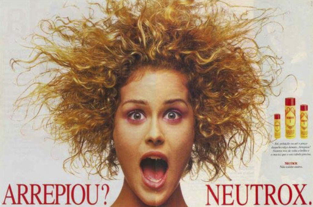 anúncio publicitário Neutrox. Texto: "Arrepiou? Neutrox." Foto de mulher com expressão de susto e cabelos exageradamente arrepiados.